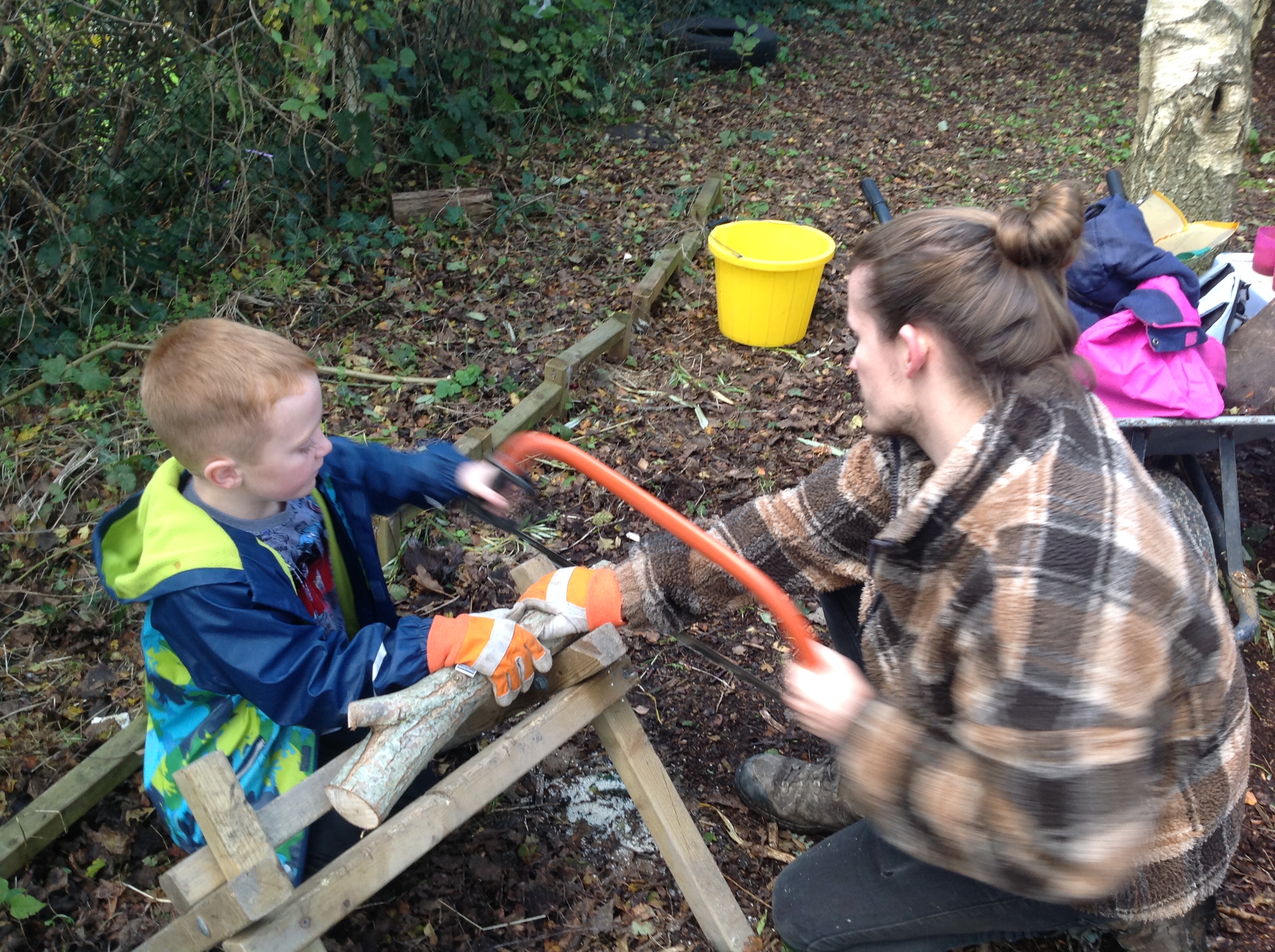 A child is learning to use tools safely.